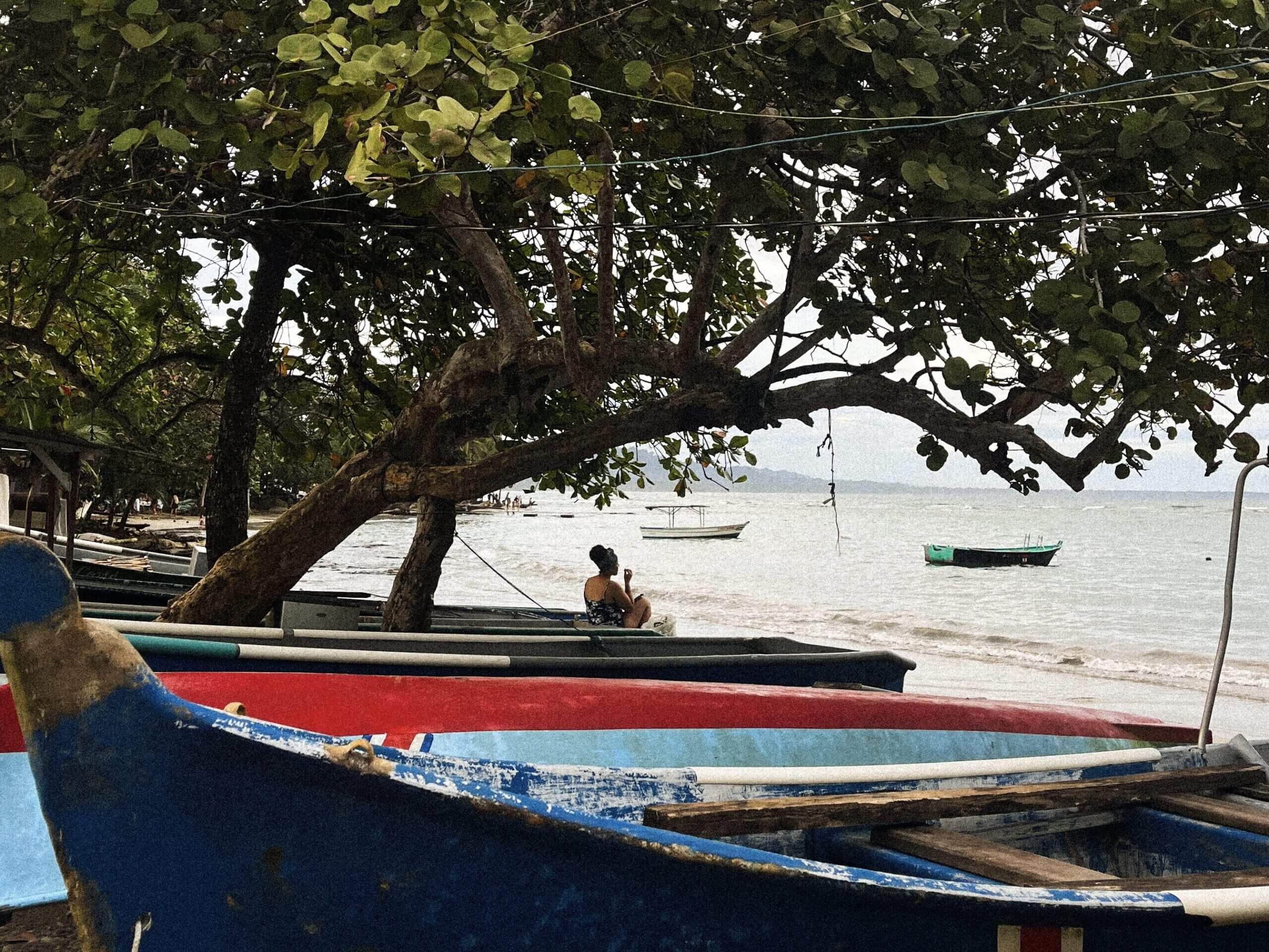 Girl sitting on beach in Costa Rica